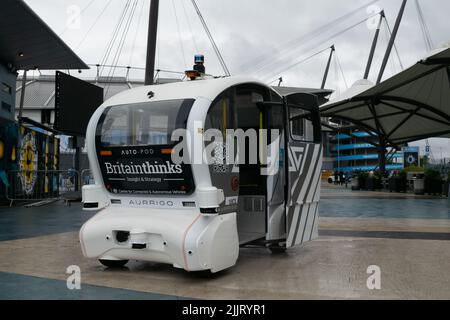 tihad Campus. Driverless white car in rain with text Centre for Connected and Autonomous Vehicles. Sensor shielded from rain. Manchester UK. Stock Photo