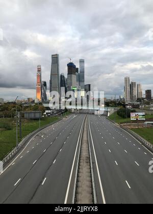 The view of Moscow City skyscrapers with an empty highway road in the foreground, vertical Stock Photo