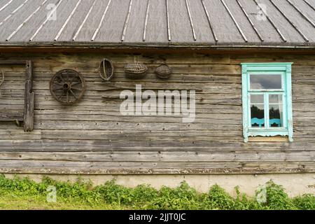 Old village house in the Russian Slavic tradition. Wooden wall and window of classic rustic architecture. High quality photo Stock Photo