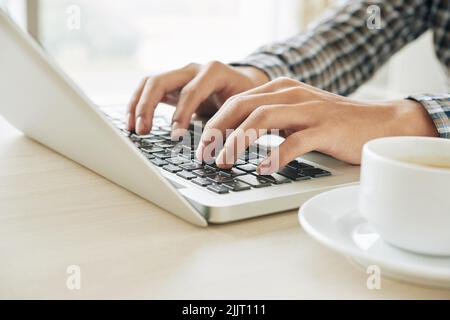 Close-up image of software developer working on laptop Stock Photo