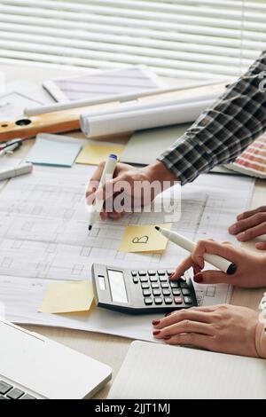 Hands of architecs counting budget for the project Stock Photo