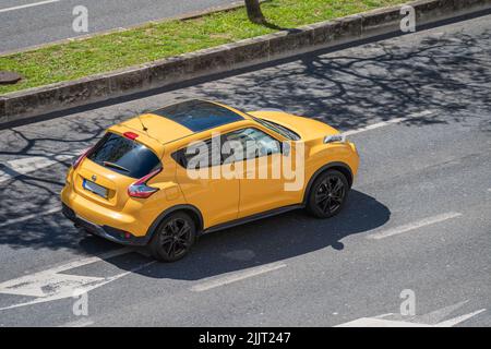 A photo of a yellow Nissan Juke SUV Coupe car on the streets of Lisbon Stock Photo