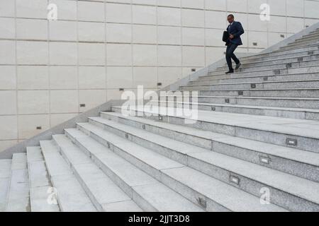 African-American business executive going down the stairs Stock Photo