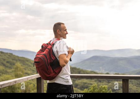 Hiker cheering elated and blissful after hiking Stock Photo