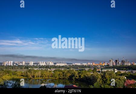 KYIV, UKRAINE - JULY 28 2022: Smoke rises over the city skyline after Russian ballistic missile strikes from the territory of Belarus on the outskirts Stock Photo