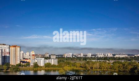 KYIV, UKRAINE - JULY 28 2022: Smoke rises over the city skyline after Russian ballistic missile strikes from the territory of Belarus on the outskirts Stock Photo