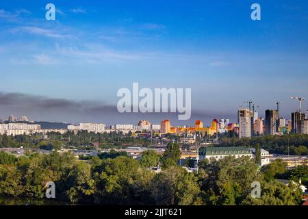 KYIV, UKRAINE - JULY 28 2022: Smoke rises over the city skyline after Russian ballistic missile strikes from the territory of Belarus on the outskirts Stock Photo