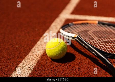 Broken tennis racket on clay tennis court Stock Photo