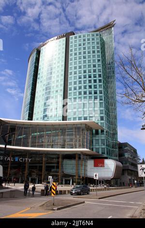 A vertical shot of Central Surrey mall and office building against blue cloudy sky on a sunny day in British Columbia, Canada Stock Photo