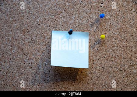 A piece of a blank paper pin on a corkboard Stock Photo