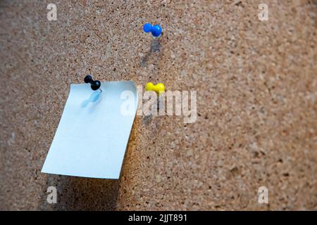 A piece of a blank paper pinned on a corkboard Stock Photo
