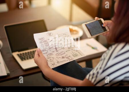 Document with charts and drawings of general idea in hands on young woman Stock Photo