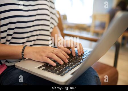 Close-up image of young woman working on laptop at home Stock Photo