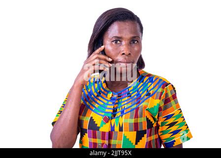 beautiful serious adult woman standing and talking on mobile phone. Stock Photo