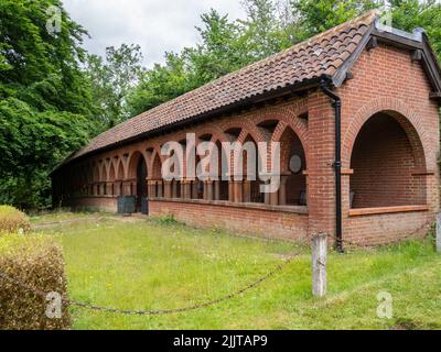 Red brick cloisters in the grounds of the Watts Chapel, Compton, Surrey, UK Stock Photo