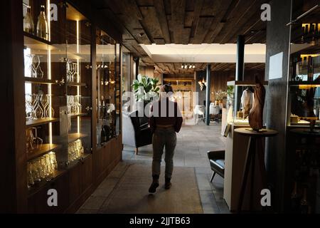 A Caucasian female seen from behind, walking in a beautifully decorated hotel in South Tyrol, Italy Stock Photo