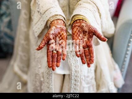 The hands of a female painted with henna Stock Photo