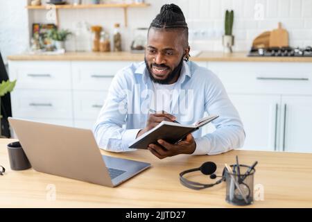 Portrait of smiling confident businessman using laptop computer Remote work concept Stock Photo