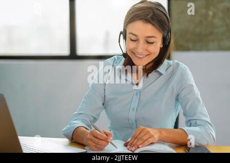 Portrait of happy female employee customer support services in headset online consultation Woman call center Stock Photo