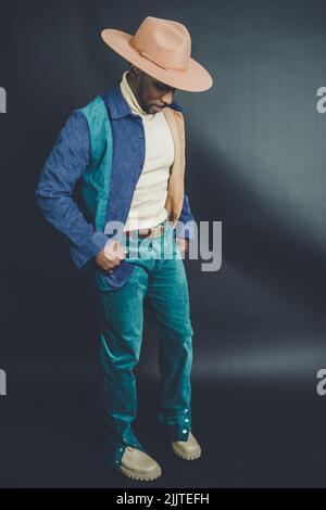 An African American man from US in a hat and casual outfit posing in a photo studio Stock Photo