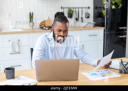 Portrait of confident businessman freelancer analyzing annual sales chart Man working remotely from home Stock Photo