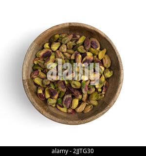 peeled pistachios in wooden bowl isolated on white background, top view, green pistachio, healthy snack Stock Photo