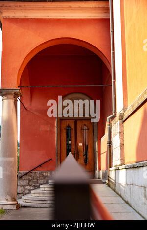 The door and stairs on an old building with arch design and classic column Stock Photo