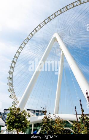 A vertical low angle shot of the Ain Dubai Ferris wheel against a blue sky in Bluewaters Island, Dubai, United Arab Emirates Stock Photo