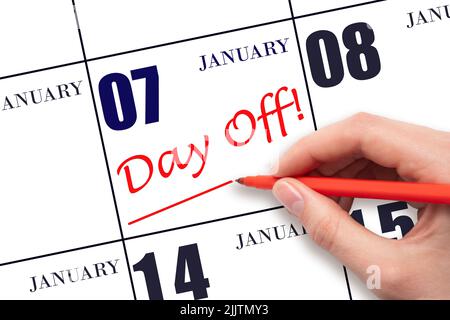 7th day of January. Hand writing text DAY OFF and drawing a line on calendar date 7 January. Vacation planning concept. Winter month, day of the year Stock Photo