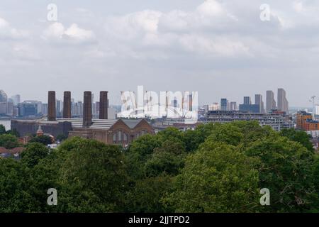 London, Greater London, England, July 20 2022: O2 Arena previously the Millennium Dome with nearby chimney stacks in North Greenwich.