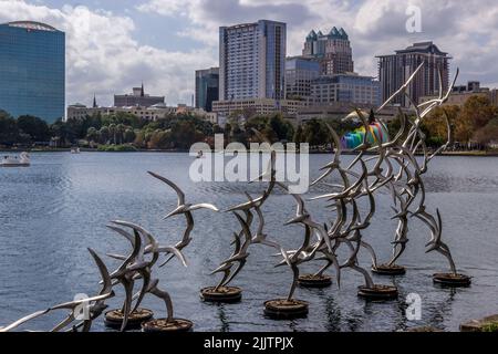 A sculpture of a flock of birds taking off in the Lake Eola in Orlando, Florida Stock Photo