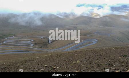 A road from Dingri county to Mount Everest under a cloudy sky Stock Photo