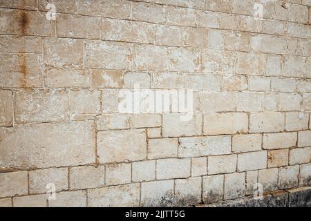 A beige old rough weathered wall Stock Photo