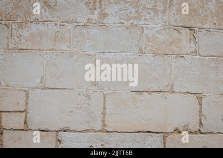 A closeup of a beige old rough weathered wall Stock Photo