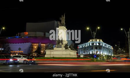 The statue of I.C.Bratianu from University Square in downtown Bucharest, Romania with car lights in long exposure Stock Photo