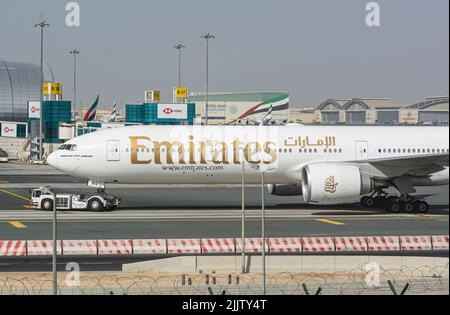 An Emirate Airline Boeing 777 300 ER parking in Dubai International Airport Stock Photo