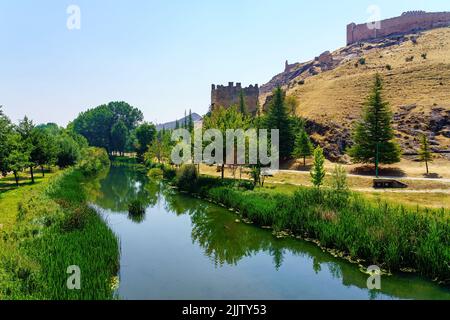 Ucero river passing quietly next to the wall of the medieval city of Burgo de Osma, Soria. Stock Photo