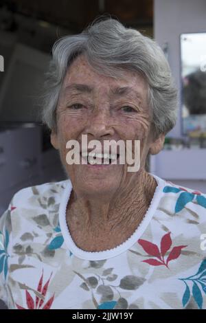 84 year old, traveler, pensioner, Thelma Evans with her Toyota Hi-Ace van in the tourist park in Winton, Queensland.   In 1988 while traveling around Ausralia in a caravan with her husband, Thelma became a widow. After a period of mourning she decided to keep traveling. She replaced the caravan with a more easily handled van and since that time she has driven over 400,000 km crisscrossing the country. She has travelled the Gibb River Road, five times and has an encyclopeadic knowledge of the roads, rivers, mountains, billabongs and campsites of Australia.  Her campervan, fitted out by her carp Stock Photo