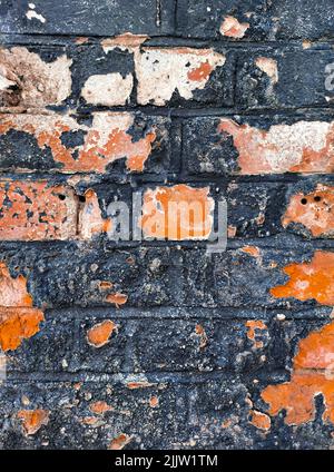 old peeled paint on blue and orange brick wall background Stock Photo