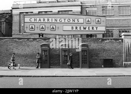 Three old style telephone boxes photographed in 1967 against a backdrop of the old Charrington's Brewery in Kings Road at Worlds End, Chelsea, London, UK Stock Photo
