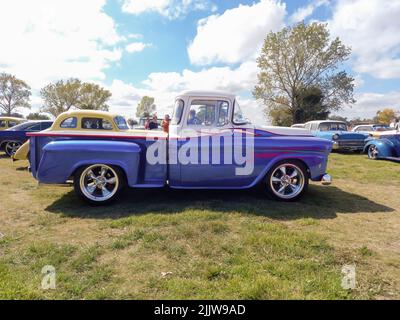 Old blue utility Chevrolet Chevy Apache V8 pickup truck 1958 by GM in the countryside. Side view. Nature grass trees. Classic car show. Copyspace Stock Photo