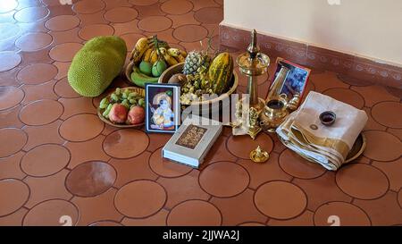 a pooja display related to an indian festival called vishu kani celebrating lord krishna and lord ram with various puja thali items Stock Photo