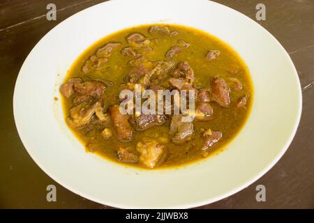 Rawon or Nasi Rawon or Rawon Rice is a strong rich tasting traditional Indonesian beef black soup served with sprouts, salted eggs, kluwek seasoning. Stock Photo