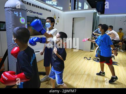 Haikou, China's Hainan Province. 28th July, 2022. Kids experience intelligent fitness facility at the second China International Consumer Products Expo (CICPE) in Haikou, south China's Hainan Province, July 28, 2022. Credit: Guo Cheng/Xinhua/Alamy Live News Stock Photo