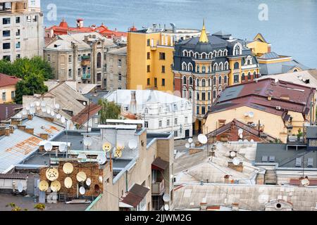 Satellite dishes on many roofs of Podil's old houses in Kyiv. Stock Photo