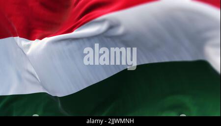 Close-up view of the Hungary national flag waving in the wind. Hungary is a landlocked country in Central Europe. Fabric textured background. Selectiv Stock Photo