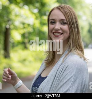 A close-up shot of a Caucasian woman smiling at the camera Stock Photo