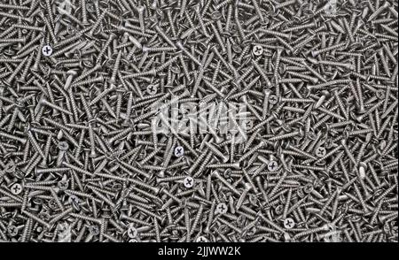 black screws texture background closeup, modern metal mix diversity Stock Photo