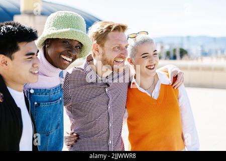 Multiracial group of young people hugging and embracing together outdoor Stock Photo