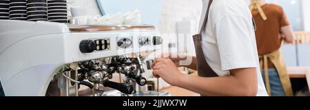Cropped view of african american barista making coffee in confectionery, banner Stock Photo